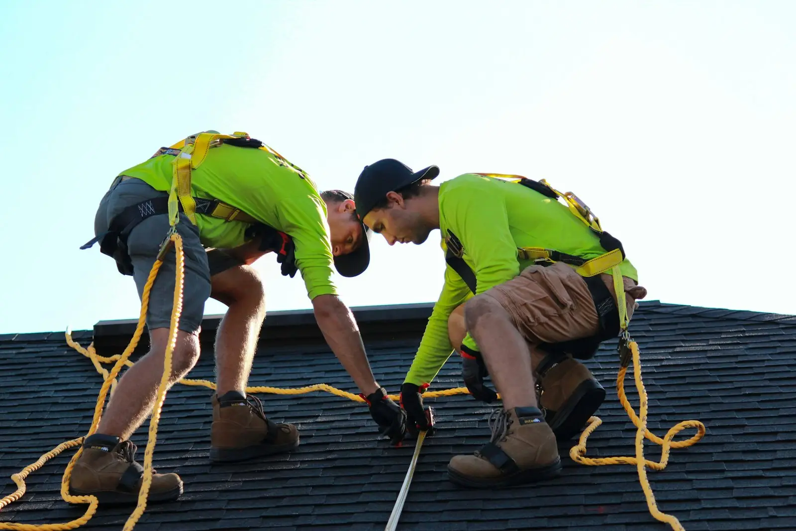 Hartline roofers measuring out a new ridge line
