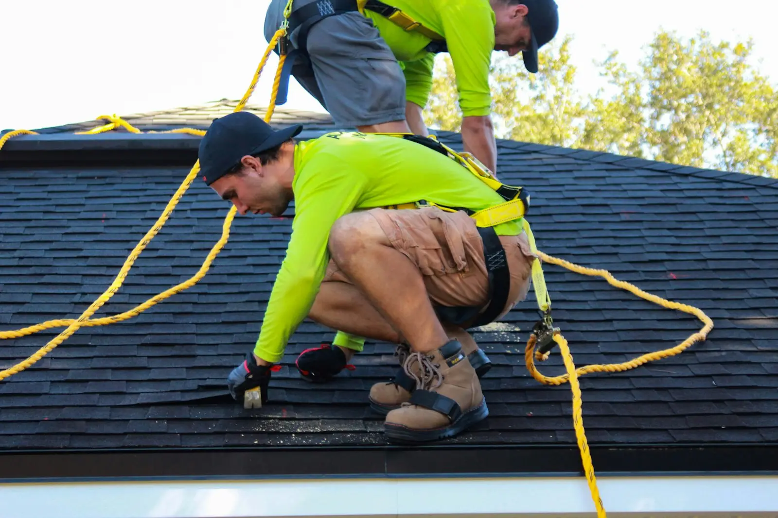 A Hartline roofer securing shingles along the ridge