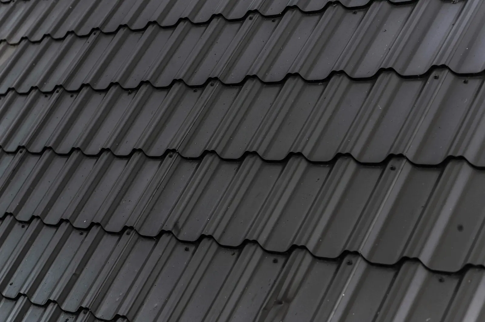 Close up of dark stone coated steel roof panels