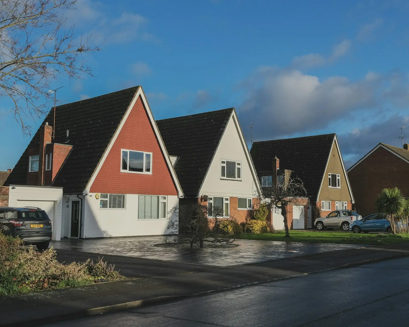 Row of steep A frame townhomes with new shingle roofs