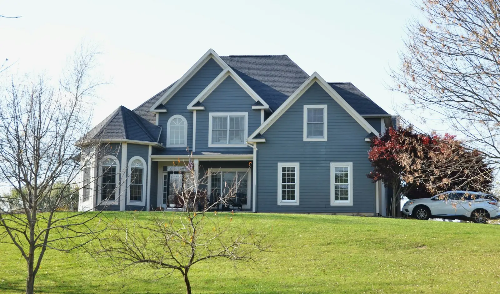 Blue two story home after a hail claim replacement